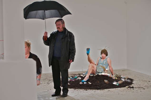LABOUR Exhibition.2012 Cummins performs in the VOID gallery, Derry. 8 hour performance with Irish women artists from north and south of Ireland. (Cummins holding umbrella).Curated by Chrissie Cadman.
